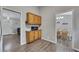 Neutral kitchenette with wood cabinets, granite countertops, and stainless microwave overlooking dining and living rooms at 3812 Stonewall Nw Dr, Kennesaw, GA 30152