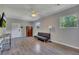 Inviting living room with wood-look flooring, neutral walls, and natural light from large windows at 3812 Stonewall Nw Dr, Kennesaw, GA 30152