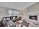 Inviting living room with a fireplace, ample natural light, and hardwood floors at 3812 Stonewall Nw Dr, Kennesaw, GA 30152