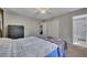 Bedroom with neutral walls, carpeted floors, ceiling fan, and a view of the en suite bathroom at 3812 Stonewall Nw Dr, Kennesaw, GA 30152