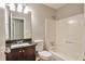 A neutral bathroom with a tub and shower, a granite countertop, and a stylish vanity at 5379 Winslow Xing, Lithonia, GA 30038