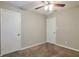 Bedroom features neutral walls, ceiling fan, and two closets at 5379 Winslow Xing, Lithonia, GA 30038