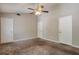 Bedroom features neutral walls, carpet, and three closets at 5379 Winslow Xing, Lithonia, GA 30038