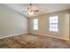 Bedroom with neutral walls, carpet, and two windows at 5379 Winslow Xing, Lithonia, GA 30038