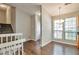 Inviting dining area featuring hardwood floors, large windows, and an elegant chandelier at 5379 Winslow Xing, Lithonia, GA 30038