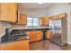 Modern kitchen with stainless steel appliances, granite countertops, and natural wood cabinets at 5379 Winslow Xing, Lithonia, GA 30038