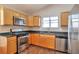 Bright kitchen featuring stainless steel appliances, granite countertops, and wooden cabinets at 5379 Winslow Xing, Lithonia, GA 30038