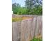 A fenced backyard with a lawn, some trees, and a fence at 713 Dove Tree Ln, Social Circle, GA 30025