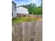 Fenced backyard with a lush lawn and a tranquil setting is perfect for outdoor activities and relaxation at 713 Dove Tree Ln, Social Circle, GA 30025