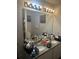 Bathroom with a double sink vanity, granite countertop, and modern light fixtures at 713 Dove Tree Ln, Social Circle, GA 30025