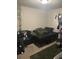 Bedroom with carpet flooring, large bed, and a sofa to sit and relax on after a long day at 713 Dove Tree Ln, Social Circle, GA 30025