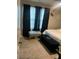 Bedroom with carpet, a queen size bed, motivational decor, and a bench to sit and relax on at 713 Dove Tree Ln, Social Circle, GA 30025