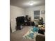 Cozy bedroom with a large window, a work desk, and a comfortable seating area at 713 Dove Tree Ln, Social Circle, GA 30025