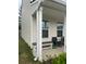 Exterior view of a home with a covered entry, neutral siding, and seating area at 713 Dove Tree Ln, Social Circle, GA 30025