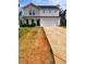 Charming two-story home with a two-car garage and a well-manicured front lawn at 713 Dove Tree Ln, Social Circle, GA 30025
