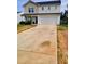 Two-story home featuring a two-car garage and a concrete driveway at 713 Dove Tree Ln, Social Circle, GA 30025