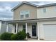 Exterior view of a home with a two-car garage, covered entry, and manicured shrubs at 713 Dove Tree Ln, Social Circle, GA 30025