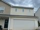 Exterior view of a home with a two-car garage and neutral siding at 713 Dove Tree Ln, Social Circle, GA 30025