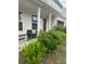 Inviting front porch with seating and well-maintained landscaping at 713 Dove Tree Ln, Social Circle, GA 30025