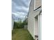 View of the side yard showcasing the lawn and exterior of the home at 713 Dove Tree Ln, Social Circle, GA 30025
