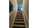 Carpeted stairway with a white railing leading to the upper level of the home at 713 Dove Tree Ln, Social Circle, GA 30025