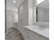 Modern bathroom features double sinks, granite countertops, and tile flooring at 963 Forrest St, Roswell, GA 30075