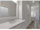 Clean bathroom featuring marble countertops, modern fixtures, and ample cabinet space at 963 Forrest St, Roswell, GA 30075