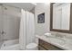Charming bathroom featuring gray tile, granite countertops, shower-tub with a white shower curtain at 963 Forrest St, Roswell, GA 30075