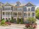 Street view of attractive townhomes with colorful flowers in the front at 963 Forrest St, Roswell, GA 30075