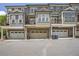 View of townhome garages below units with balconies at 963 Forrest St, Roswell, GA 30075