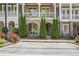 Charming townhouse exterior with brick facade, manicured landscaping, and inviting front porch at 963 Forrest St, Roswell, GA 30075
