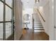 Welcoming foyer with hardwood floors, staircase, and modern lighting at 963 Forrest St, Roswell, GA 30075