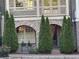 Charming brick townhome entrance with arched doorways and decorative landscaping at 963 Forrest St, Roswell, GA 30075