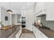 Kitchen featuring stainless steel appliances, a center island, and ample cabinet space at 963 Forrest St, Roswell, GA 30075