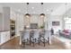 Modern kitchen featuring stainless steel appliances, an island with seating, and hardwood floors at 963 Forrest St, Roswell, GA 30075