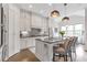 Bright kitchen with stainless steel appliances, island with bar seating, and modern lighting at 963 Forrest St, Roswell, GA 30075