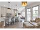 Open-concept kitchen with island seating and stainless steel appliances flowing into a living area at 963 Forrest St, Roswell, GA 30075