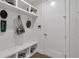 Well-organized mudroom featuring shelving, hooks, a bench with shoe storage, and white wainscotting at 963 Forrest St, Roswell, GA 30075