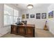 Bright office with a large window and a handsome wood desk with wall decorations and guitar at 963 Forrest St, Roswell, GA 30075