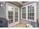 Outdoor patio features grill, seating area and large windows allowing light into the home at 963 Forrest St, Roswell, GA 30075