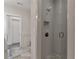 Walk-in shower features neutral tile and glass door at 963 Forrest St, Roswell, GA 30075