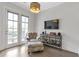 Cozy sitting area with a comfortable chair and ottoman, bathed in natural light at 963 Forrest St, Roswell, GA 30075