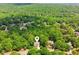 A lush aerial view of the home nestled amongst mature trees on a spacious lot at 4050 Arrow Head Trl, Cumming, GA 30041