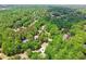 Aerial view of a home nestled among lush green trees in a residential neighborhood at 4050 Arrow Head Trl, Cumming, GA 30041