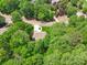 Overhead view of a home surrounded by lush trees in a tranquil, wooded neighborhood at 4050 Arrow Head Trl, Cumming, GA 30041
