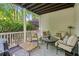 Relaxing covered porch with outdoor seating, perfect for enjoying the serene backyard views at 4050 Arrow Head Trl, Cumming, GA 30041