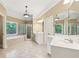 Bright bathroom with a soaking tub, glass shower, and double vanity sinks at 4050 Arrow Head Trl, Cumming, GA 30041