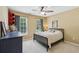Cozy bedroom with neutral walls, a ceiling fan, two windows and a black metal bed frame at 4050 Arrow Head Trl, Cumming, GA 30041
