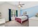 bedroom with a vaulted ceiling, a fan, and a bright blue accent wall at 4050 Arrow Head Trl, Cumming, GA 30041