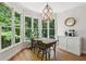 Cozy dining area with a large window view, chandelier, and breakfast nook, ideal for Gathering meals at 4050 Arrow Head Trl, Cumming, GA 30041